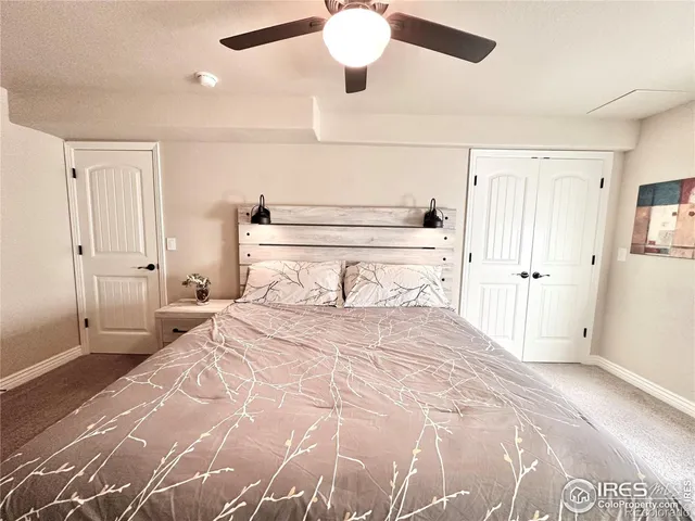 a bedroom with a large bed and a chandelier