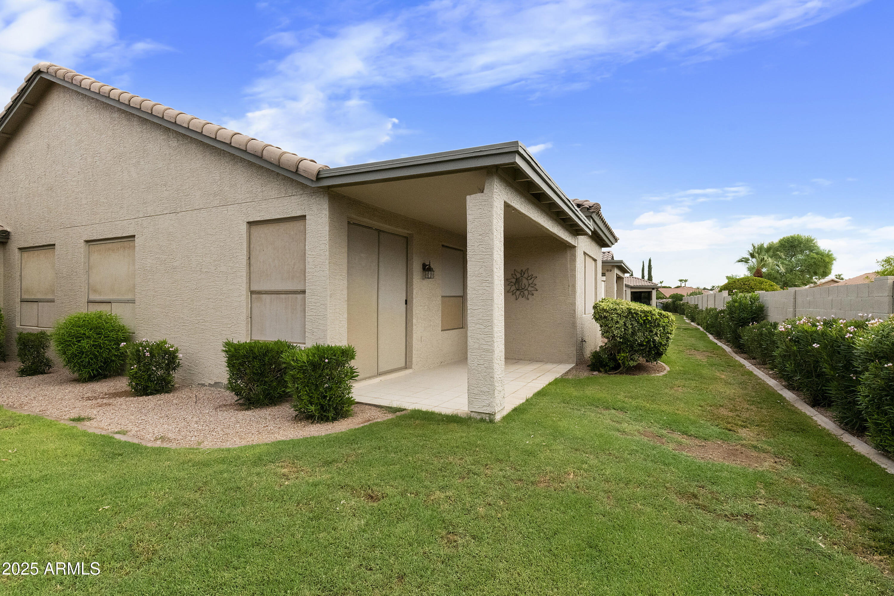 23745 South Vacation Way Sun Lakes, AZ 85248 - Photo 4 of 52 a view of an house with backyard space and garden
