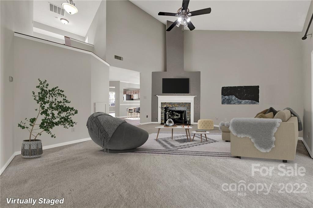 12102 Henderson Hill Road Huntersville, NC 28078 - Photo 11 of 31 a living room with furniture a fireplace and a potted plant