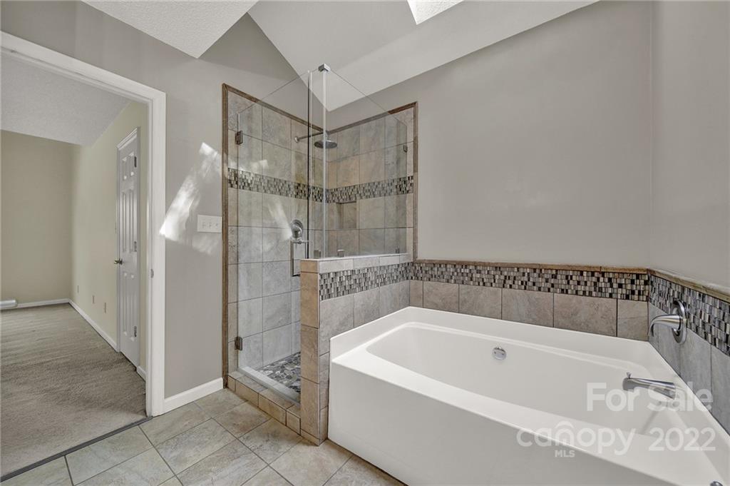 12102 Henderson Hill Road Huntersville, NC 28078 - Photo 17 of 31 a bathroom with a bathtub and a shower