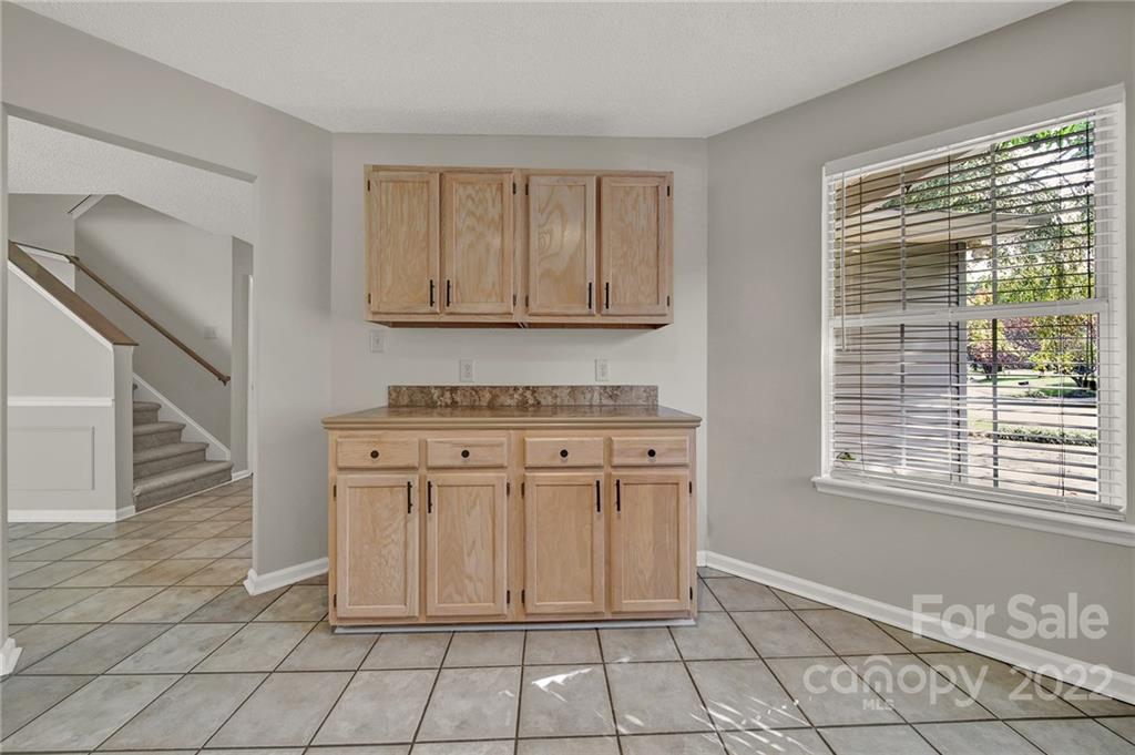 12102 Henderson Hill Road Huntersville, NC 28078 - Photo 5 of 31 a kitchen with white cabinets a sink and a window