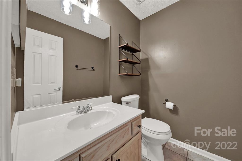 12102 Henderson Hill Road Huntersville, NC 28078 - Photo 9 of 31 a bathroom with a sink a toilet and shower