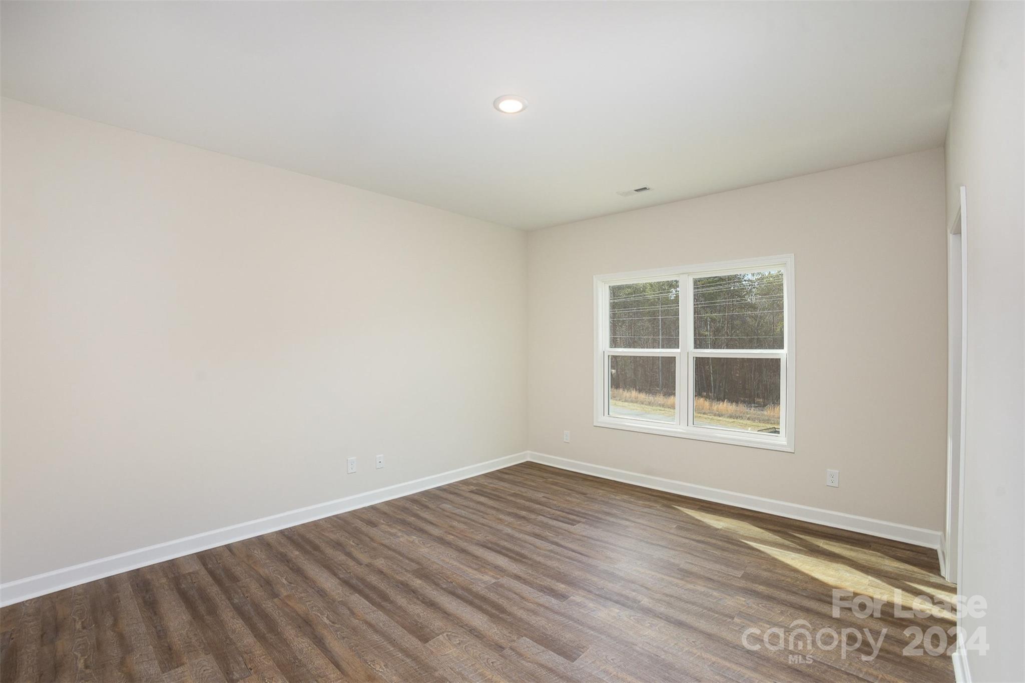 2866 Fay Jones Road Denver, NC 28037 - Photo 6 of 16 an empty room with wooden floor and windows