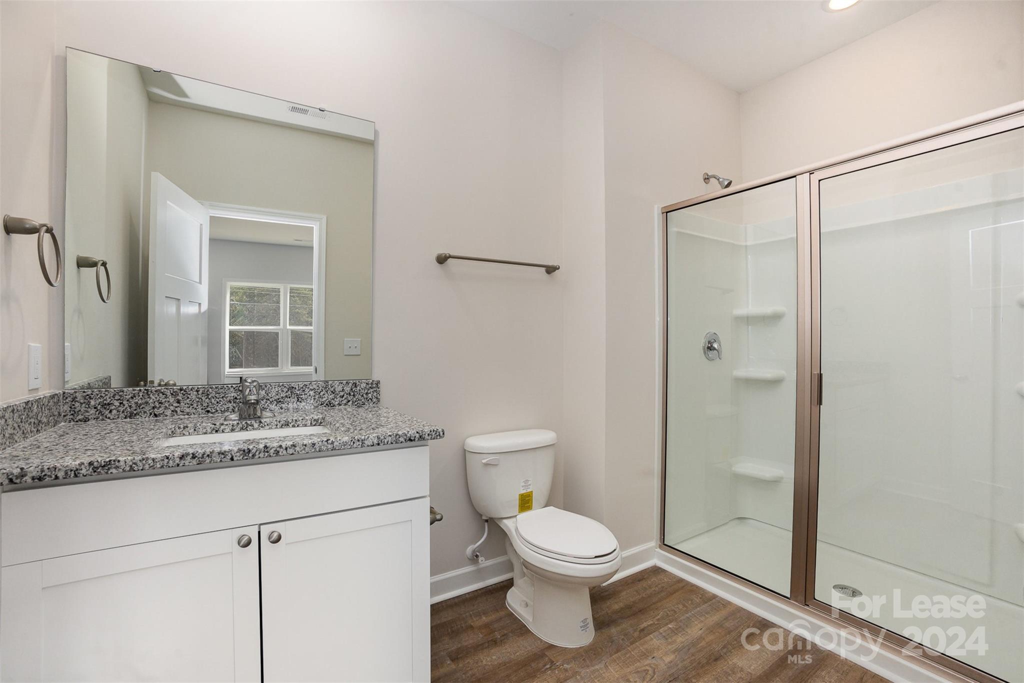 2866 Fay Jones Road Denver, NC 28037 - Photo 10 of 16 a bathroom with a granite countertop sink toilet and shower