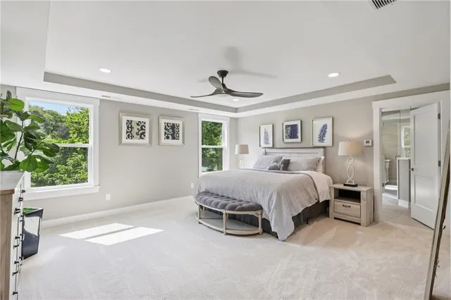 a spacious bedroom with a bed and a window