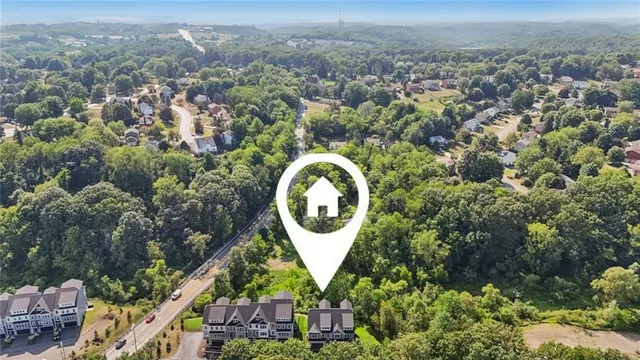 an aerial view of a house with a yard and lake view