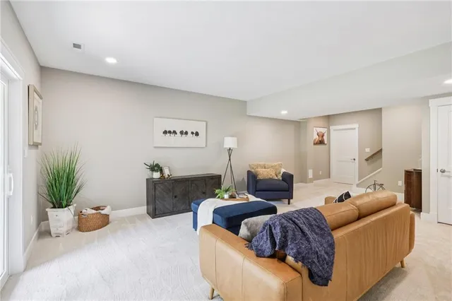 a living room with furniture and a potted plant