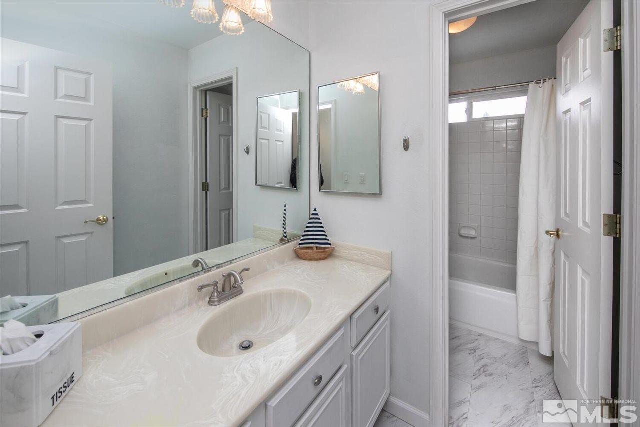 14425 Ghost Rider Drive Reno, NV 89511 - Photo 22 of 37 a bathroom with a sink and a mirror