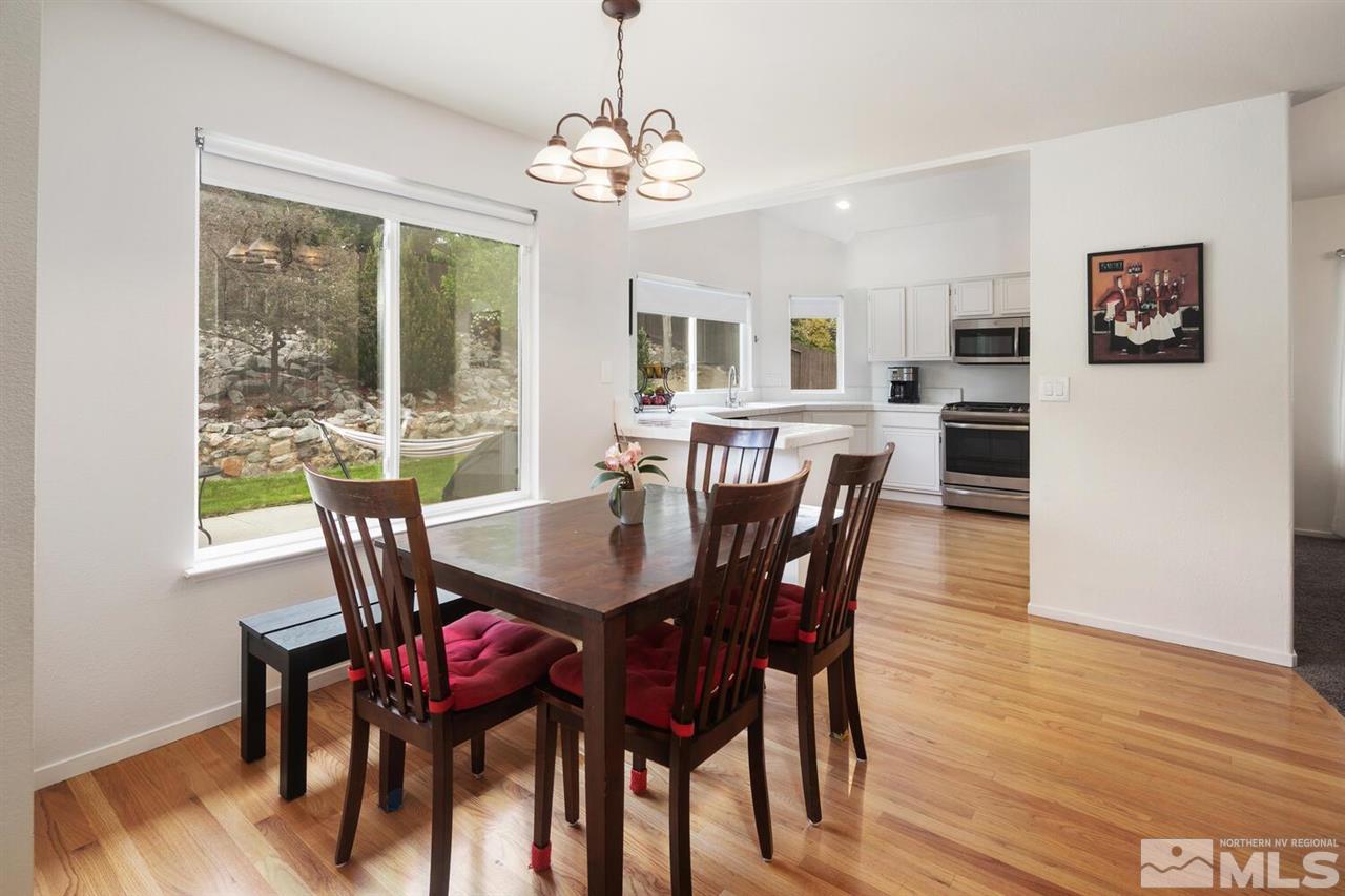 14425 Ghost Rider Drive Reno, NV 89511 - Photo 10 of 37 a view of a dining room with furniture window and wooden floor