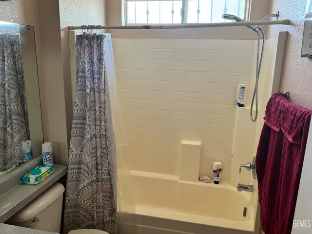 a bathroom with a bathtub and shower