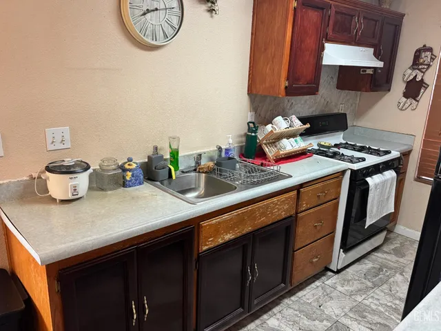a kitchen with a stove and a white cabinets