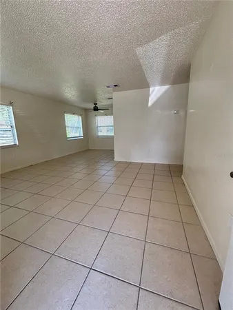 a view of a livingroom with an empty space and a window