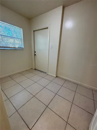 a view of an empty room and staircase