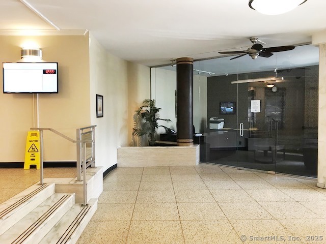 91 Strawberry Hill Avenue, Unit 925 Stamford, CT 06902 - Photo 11 of 20 a view of a hallway with the glass door and furniture