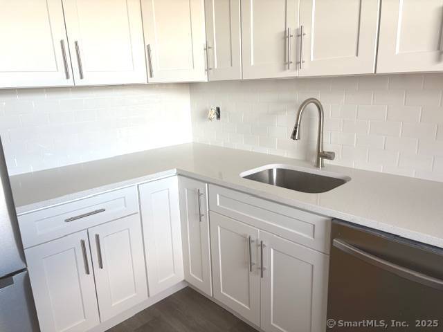 91 Strawberry Hill Avenue, Unit 925 Stamford, CT 06902 - Photo 3 of 20 a kitchen with white cabinets and a sink