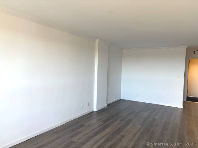 91 Strawberry Hill Avenue, Unit 925 Stamford, CT 06902 - Photo 7 of 20 a view of an empty room with wooden floor