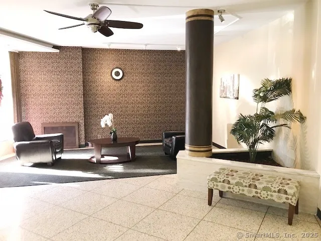 a view of a hallway with the glass door and furniture