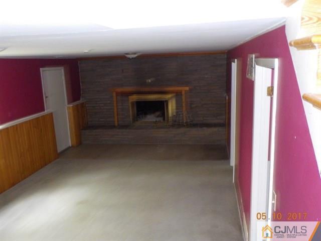 15 Nottingham Road Edison, NJ 08820 - Photo 8 of 11 a view of an empty room and fire place