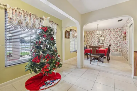 a view of a dining room with furniture and chandelier