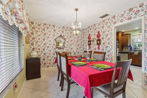 a kitchen with stainless steel appliances granite countertop a stove a sink dishwasher and a refrigerator with wooden cabinets