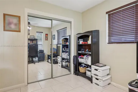 a bedroom with a bed and a lamp on dresser