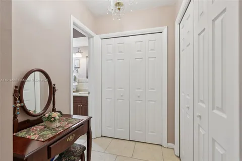 a bathroom with a granite countertop shower a mirror and a sink