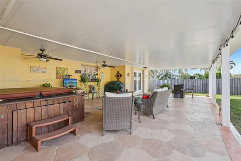 a dining room with furniture and a floor to ceiling window