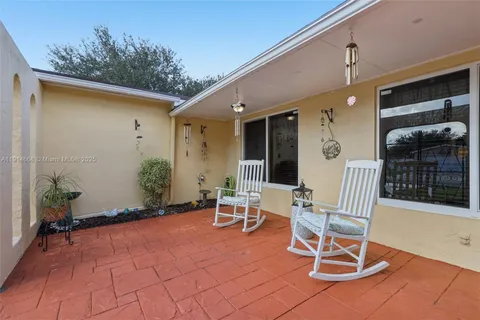 a view of a patio with a table and chairs