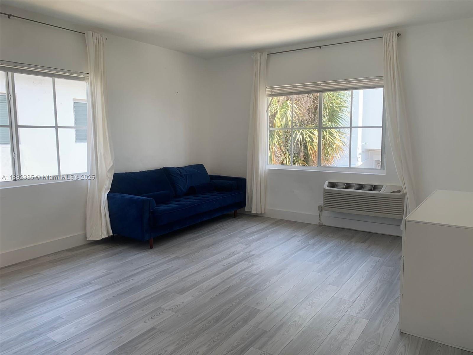 8011 Abbott Avenue, Unit 8 Miami Beach, FL 33141 - Photo 1 of 4 a living room with furniture and a window
