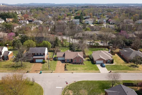 an aerial view of a house with yard swimming pool and lake view