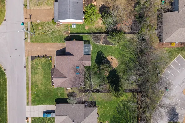 an aerial view of house with a yard