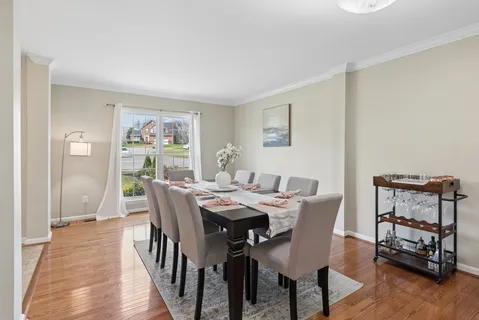a view of a dining room with furniture and wooden floor