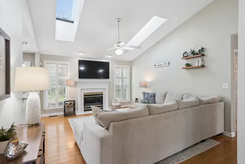 a living room with furniture a fireplace and a flat screen tv