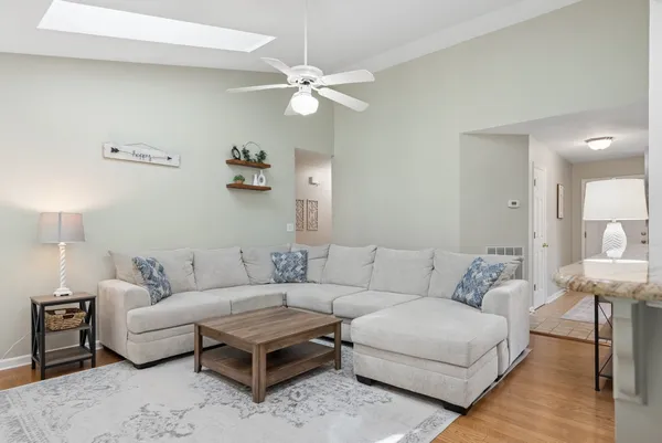 a living room with furniture and a mirror