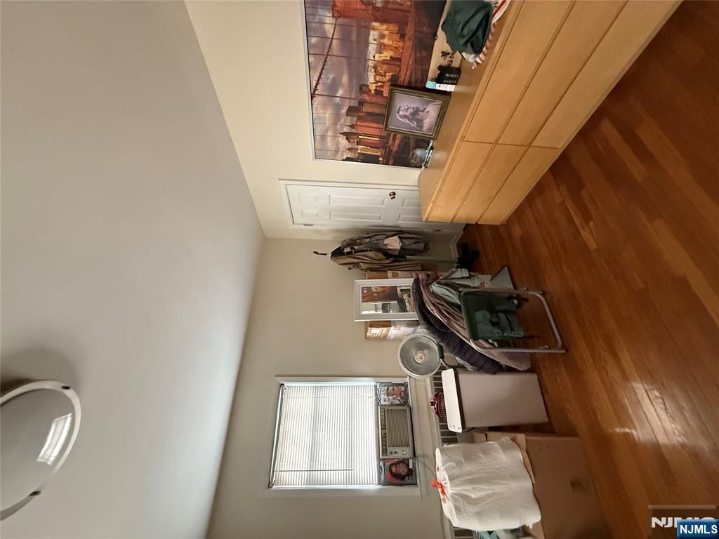 171-183 Fort Lee Road, Unit 1731C Teaneck, NJ 07666 - Photo 11 of 15 a living room with furniture a air conditioner vent and a window