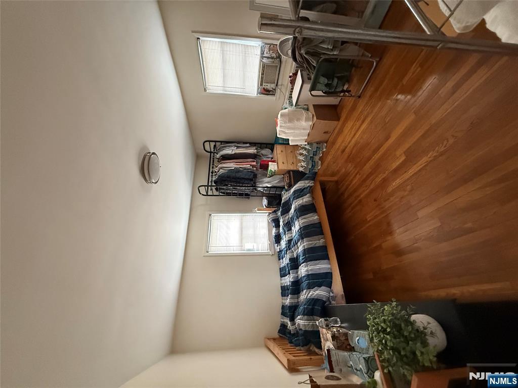171-183 Fort Lee Road, Unit 1731C Teaneck, NJ 07666 - Photo 12 of 15 a living room with lots of furniture and a flat screen tv