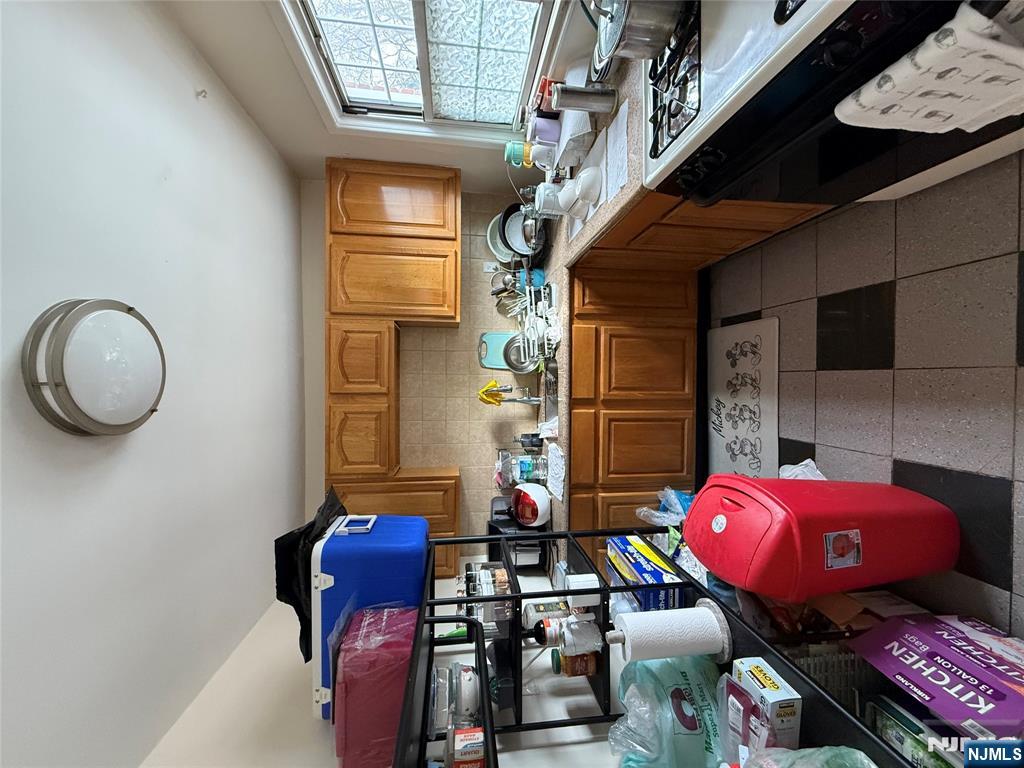 171-183 Fort Lee Road, Unit 1731C Teaneck, NJ 07666 - Photo 13 of 15 a kitchen with a sink a stove and cabinets