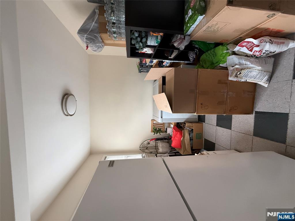 171-183 Fort Lee Road, Unit 1731C Teaneck, NJ 07666 - Photo 14 of 15 a living room with furniture and a flat screen tv