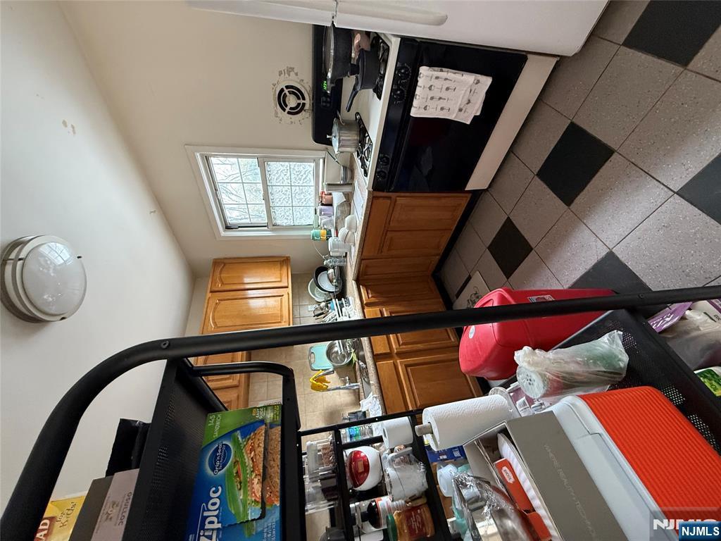 171-183 Fort Lee Road, Unit 1731C Teaneck, NJ 07666 - Photo 15 of 15 a kitchen with stainless steel appliances granite countertop a stove a sink and a microwave