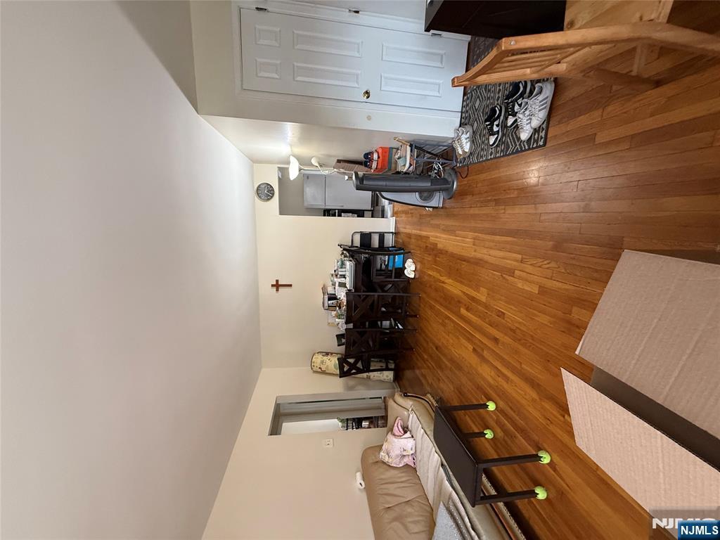171-183 Fort Lee Road, Unit 1731C Teaneck, NJ 07666 - Photo 6 of 15 a living room with furniture and a wooden floor