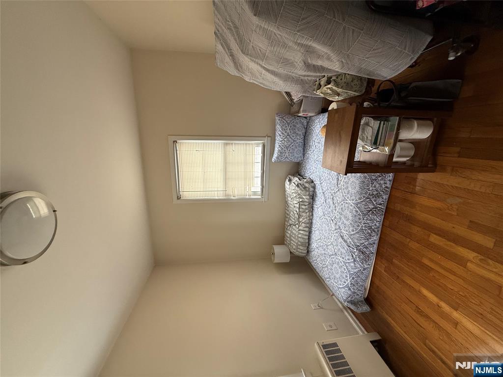 171-183 Fort Lee Road, Unit 1731C Teaneck, NJ 07666 - Photo 9 of 15 a bedroom with a bed and a window