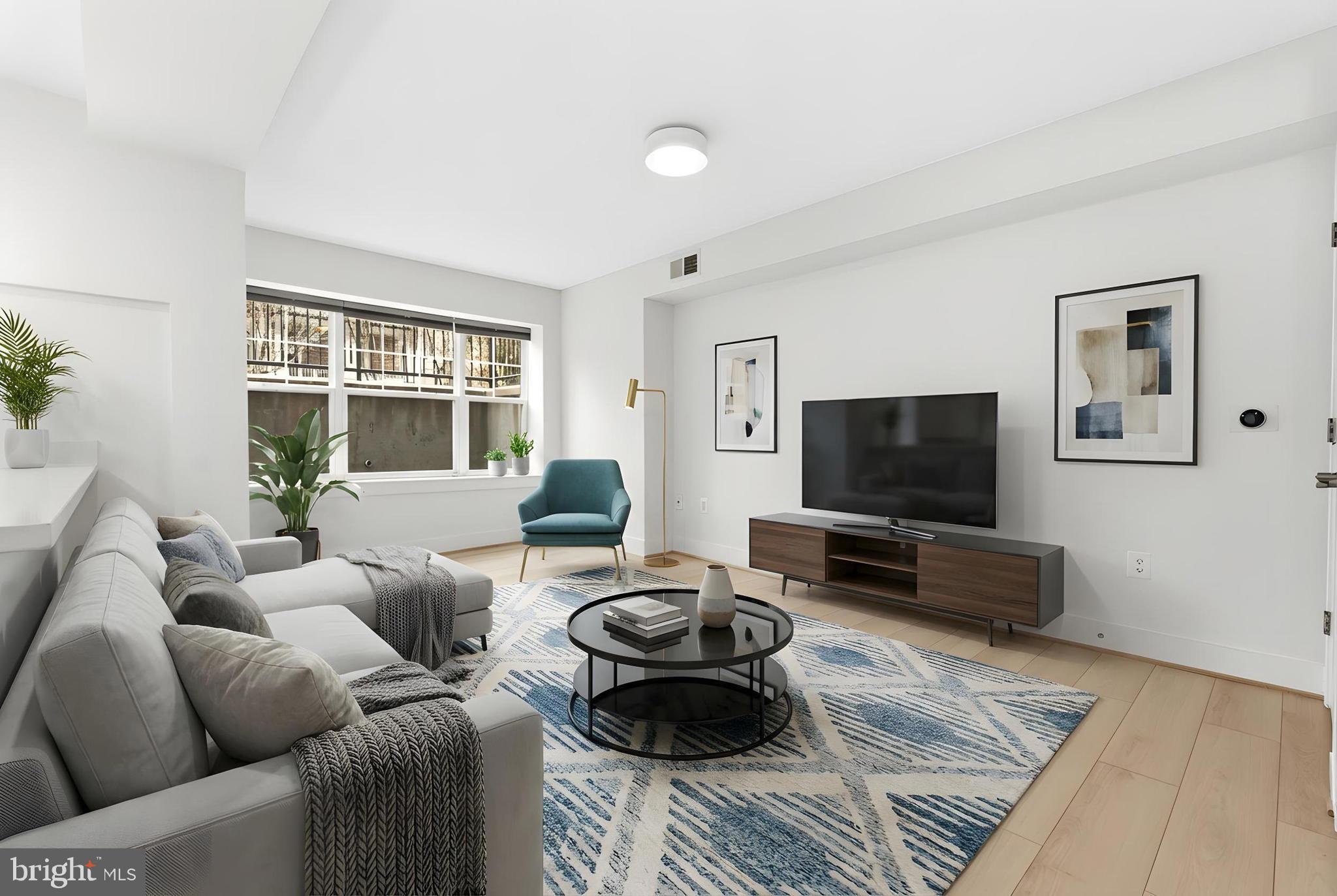 4226 7th Street Northwest, Unit 101 Washington, DC 20011 - Photo 1 of 23 a living room with furniture and a flat screen tv