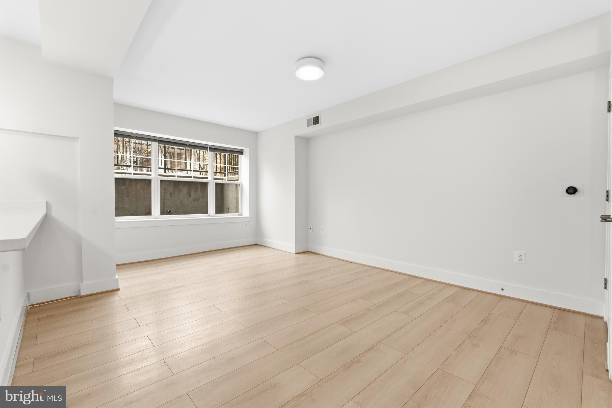 4226 7th Street Northwest, Unit 101 Washington, DC 20011 - Photo 12 of 23 a view of empty room with wooden floor and fan