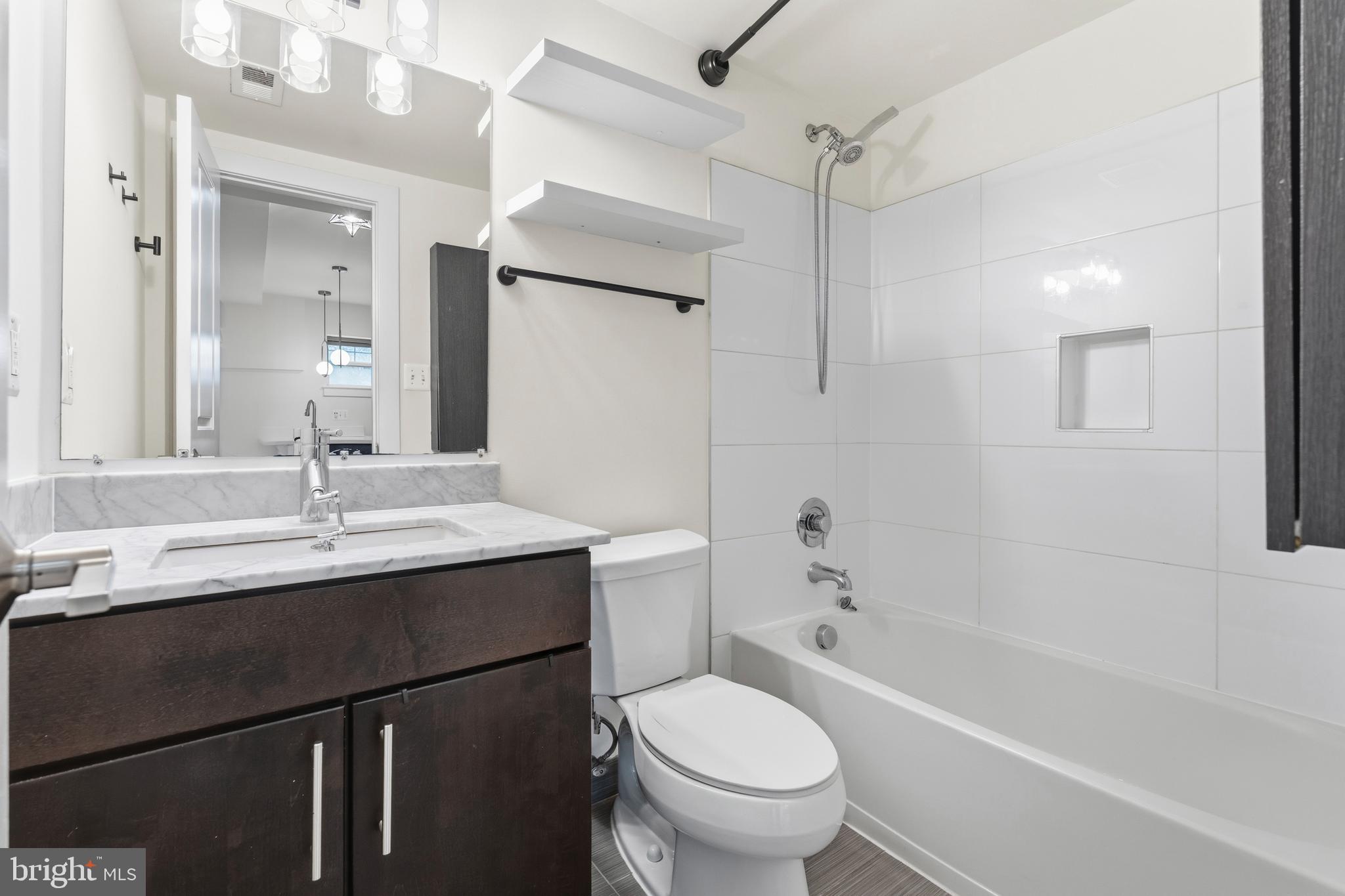 4226 7th Street Northwest, Unit 101 Washington, DC 20011 - Photo 13 of 23 a bathroom with a sink toilet vanity and shower
