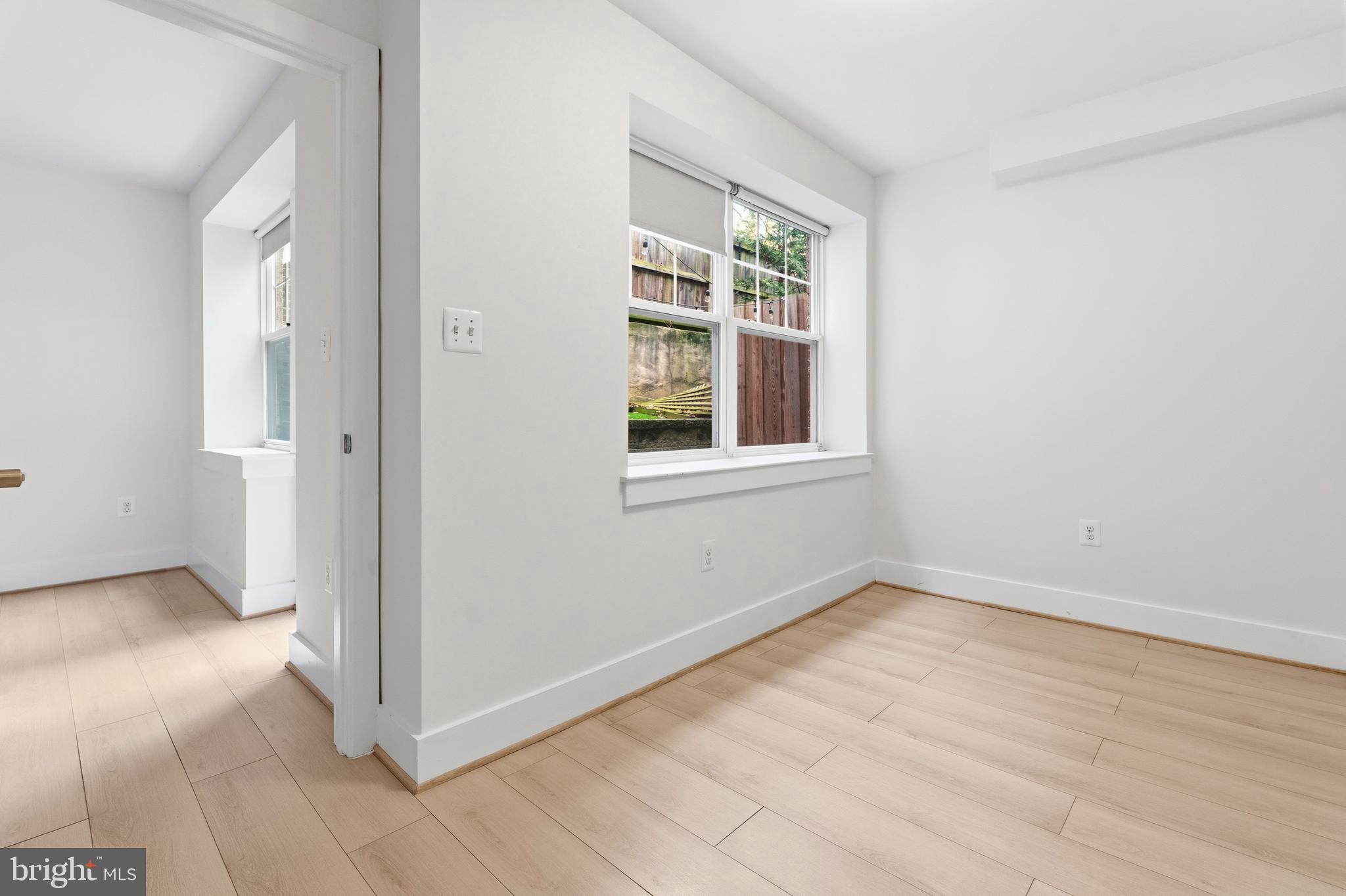 4226 7th Street Northwest, Unit 101 Washington, DC 20011 - Photo 17 of 23 an empty room with wooden floor and windows