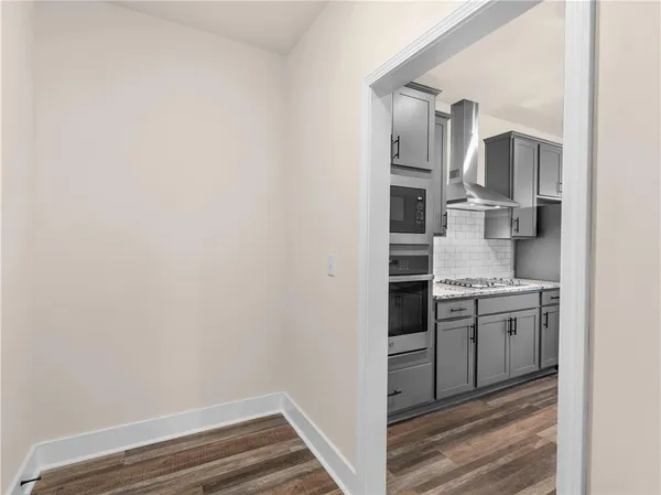 a kitchen with cabinets and stainless steel appliances