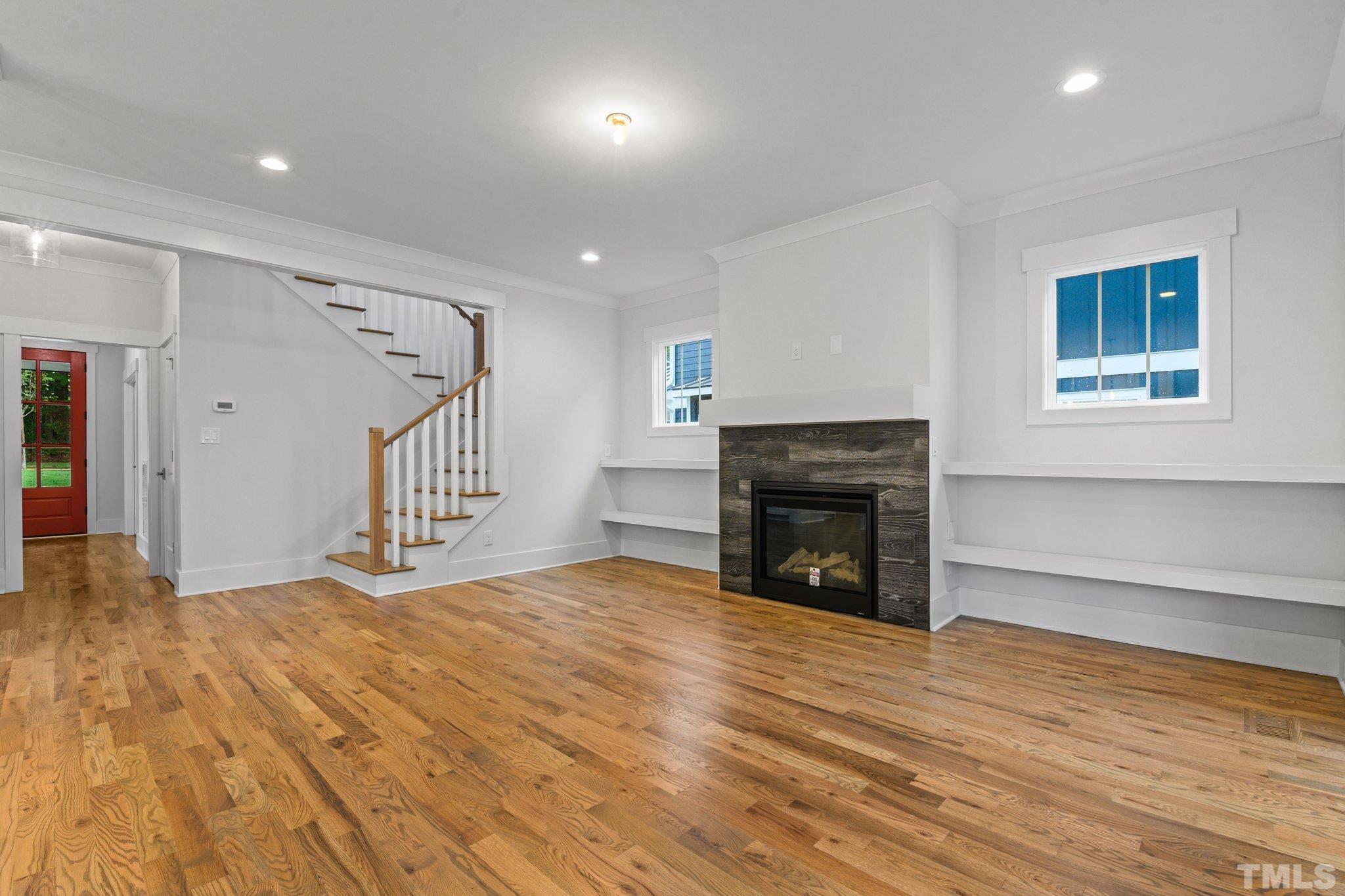 1019 Glascock Street Raleigh, NC 27610 - Photo 12 of 30 a view of empty room with wooden floor and fireplace