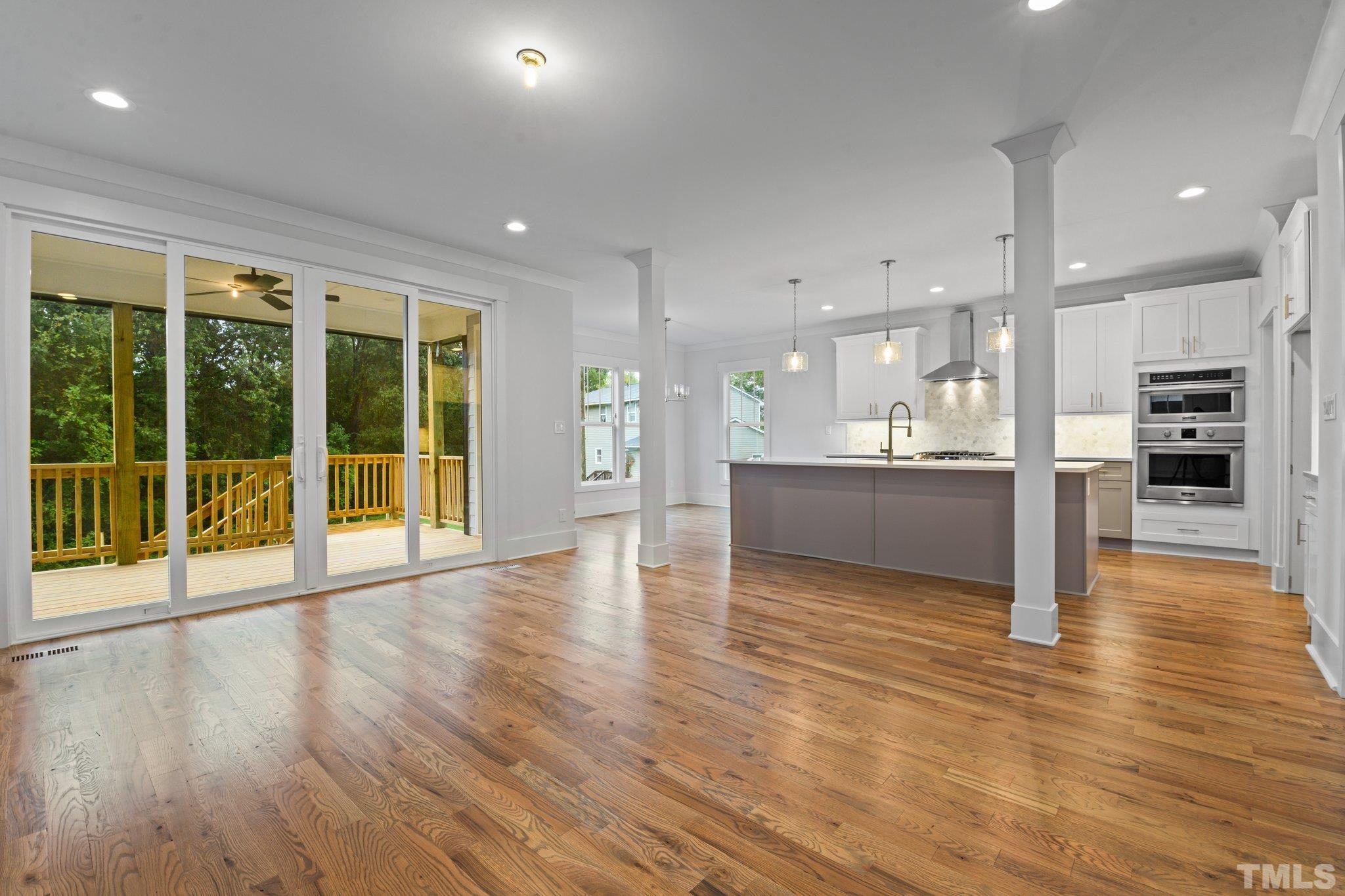 1019 Glascock Street Raleigh, NC 27610 - Photo 14 of 30 a view of a big room with wooden floor and windows