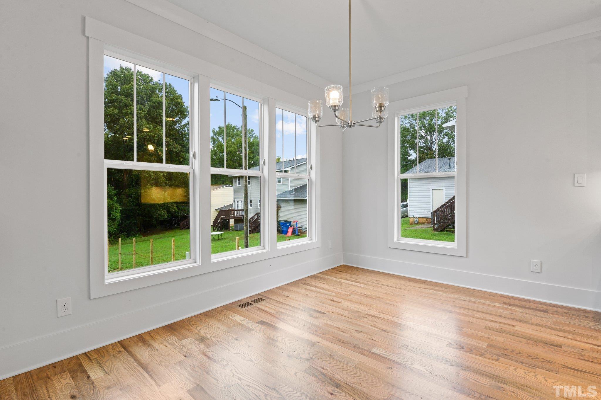 1019 Glascock Street Raleigh, NC 27610 - Photo 16 of 30 an empty room with windows and outdoor view