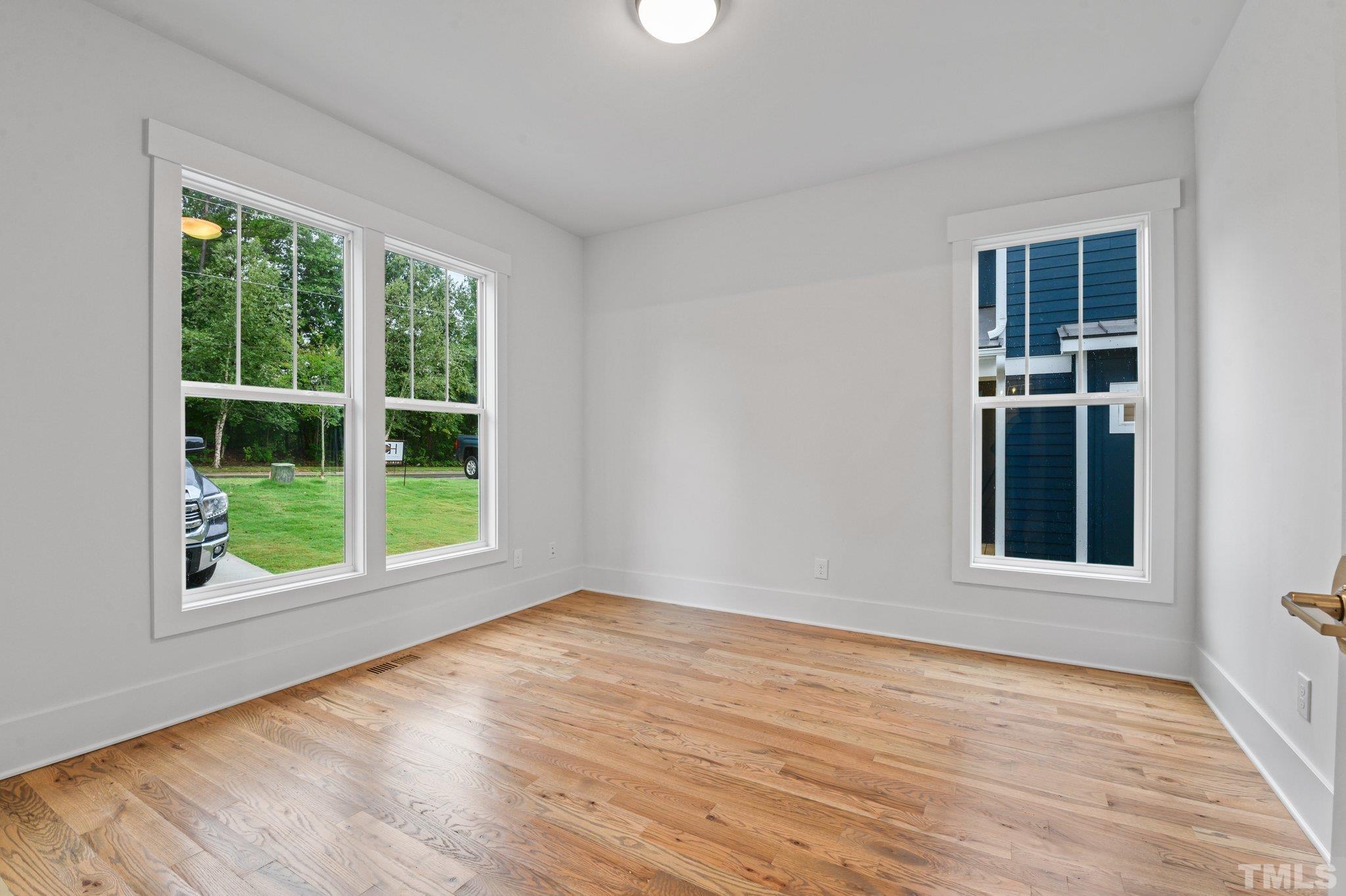1019 Glascock Street Raleigh, NC 27610 - Photo 17 of 30 a view of an empty room with a window and wooden floor